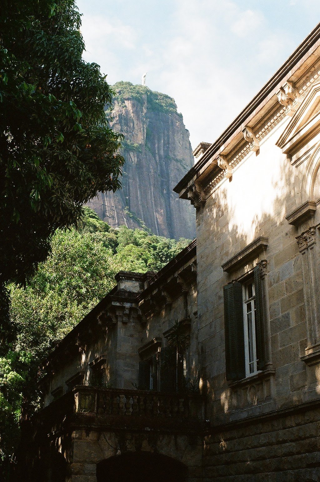 the side of a building in Paruqe Lage, with a mountain and the Christ statue in the backgrund, in Rio de Janeiro.