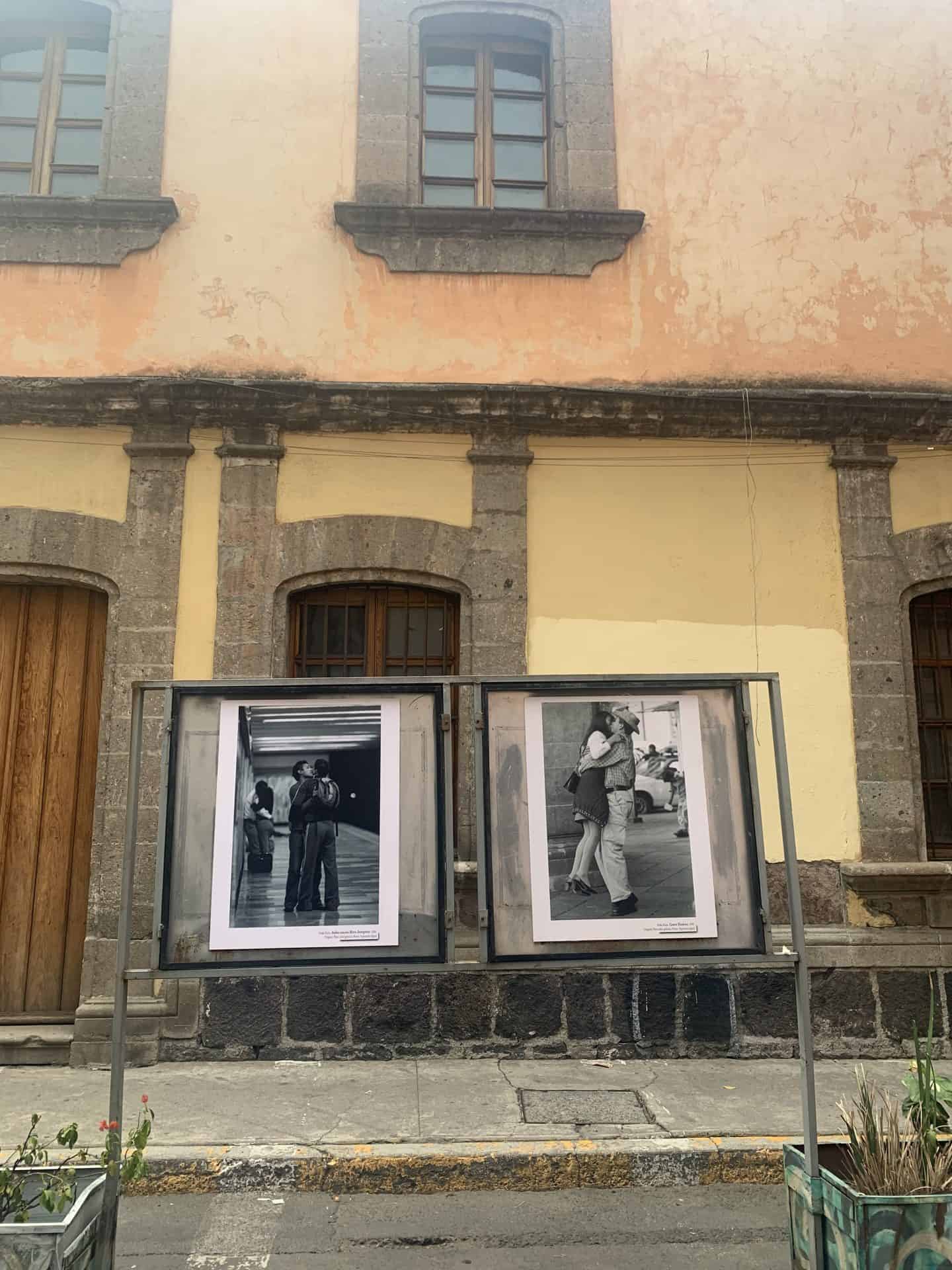 Two black-and-white-photos of couples placed in a street in front of a building in Centro, Mexico City