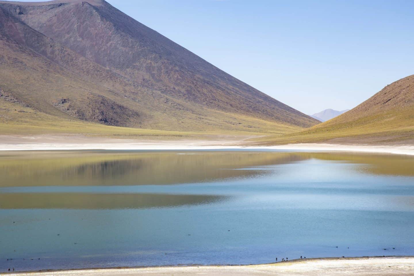 A giant blue lake with surrounding mountains in the Atacama Desert, Chile