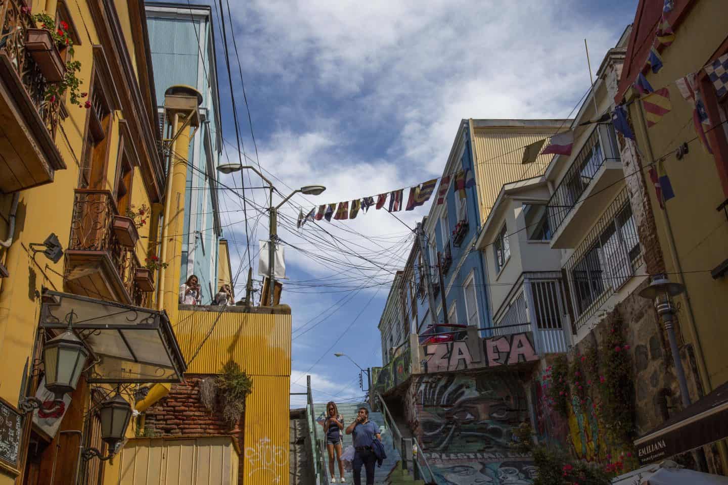 Colorful buildings with flags hanging across the sky in Valparaiso, Chile