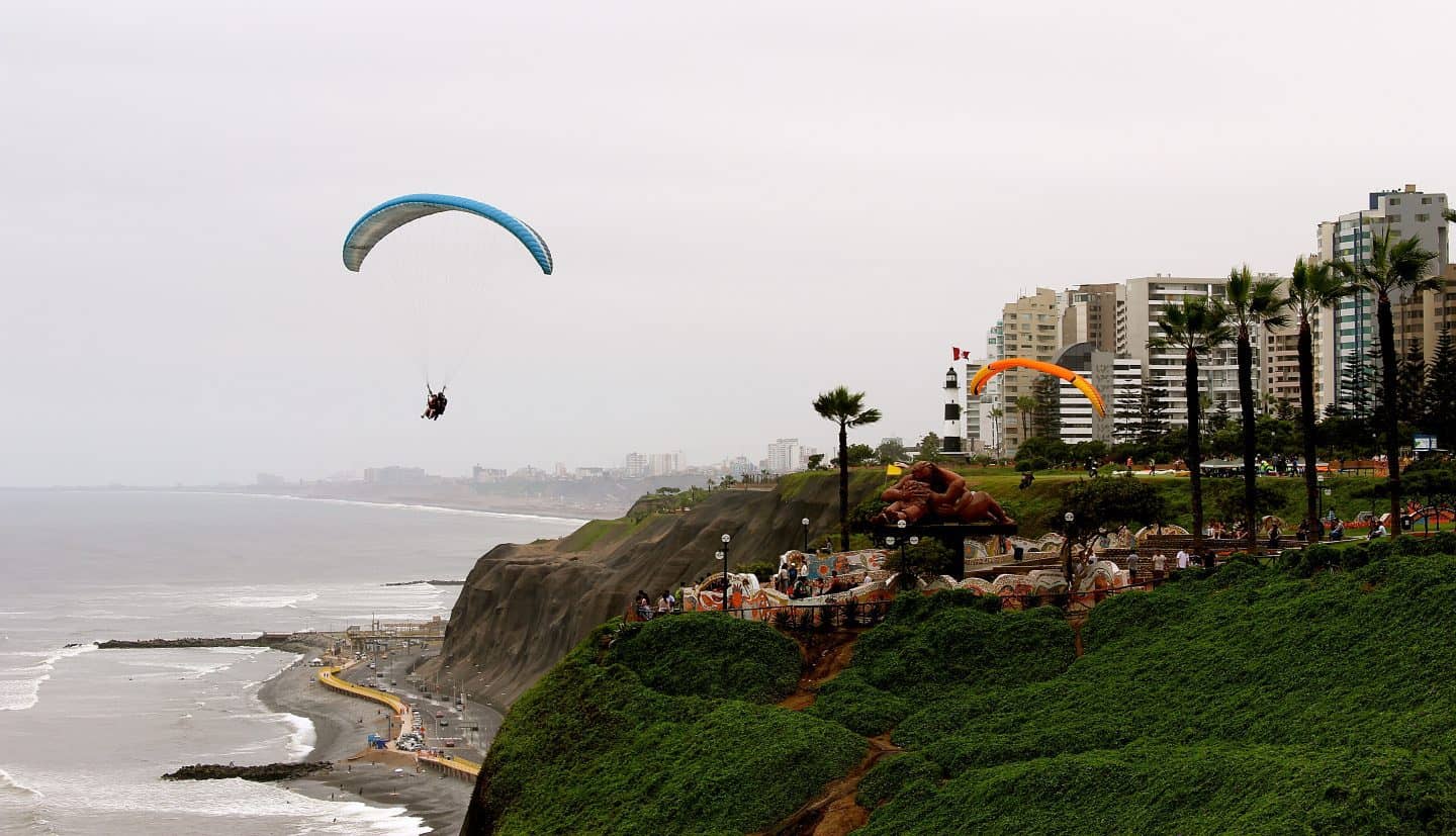 A parasail over the water with a cloudy sky in Lima, Peru