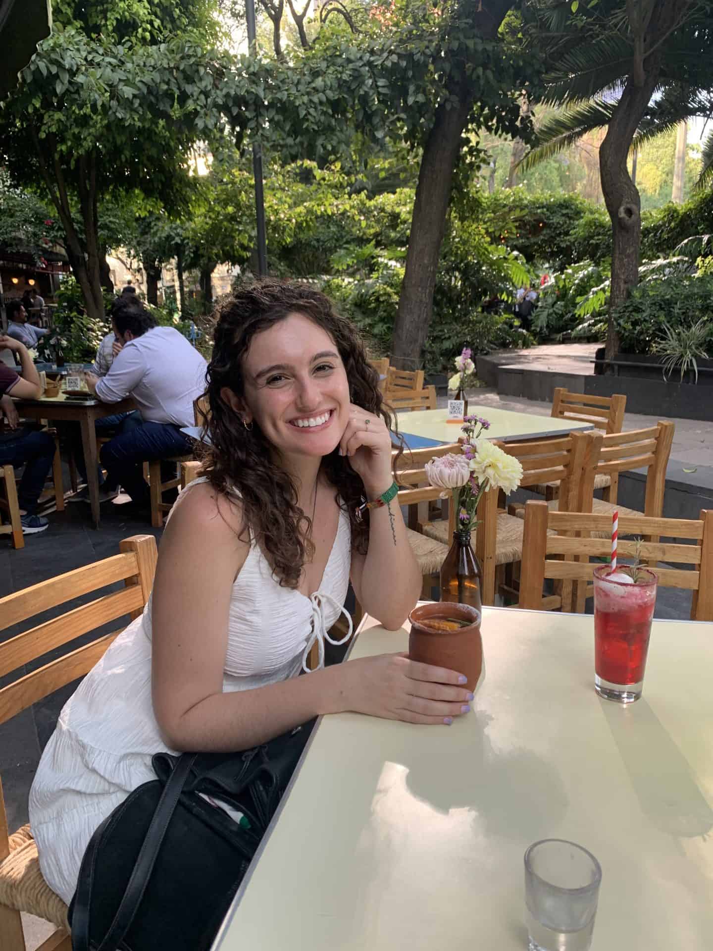 A woman sitting at a table with two cocktails in Mexico City