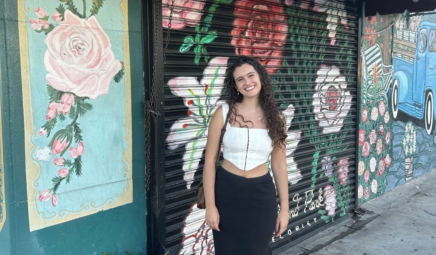 a woman standing in front of a painted garage door in Highland Park, California