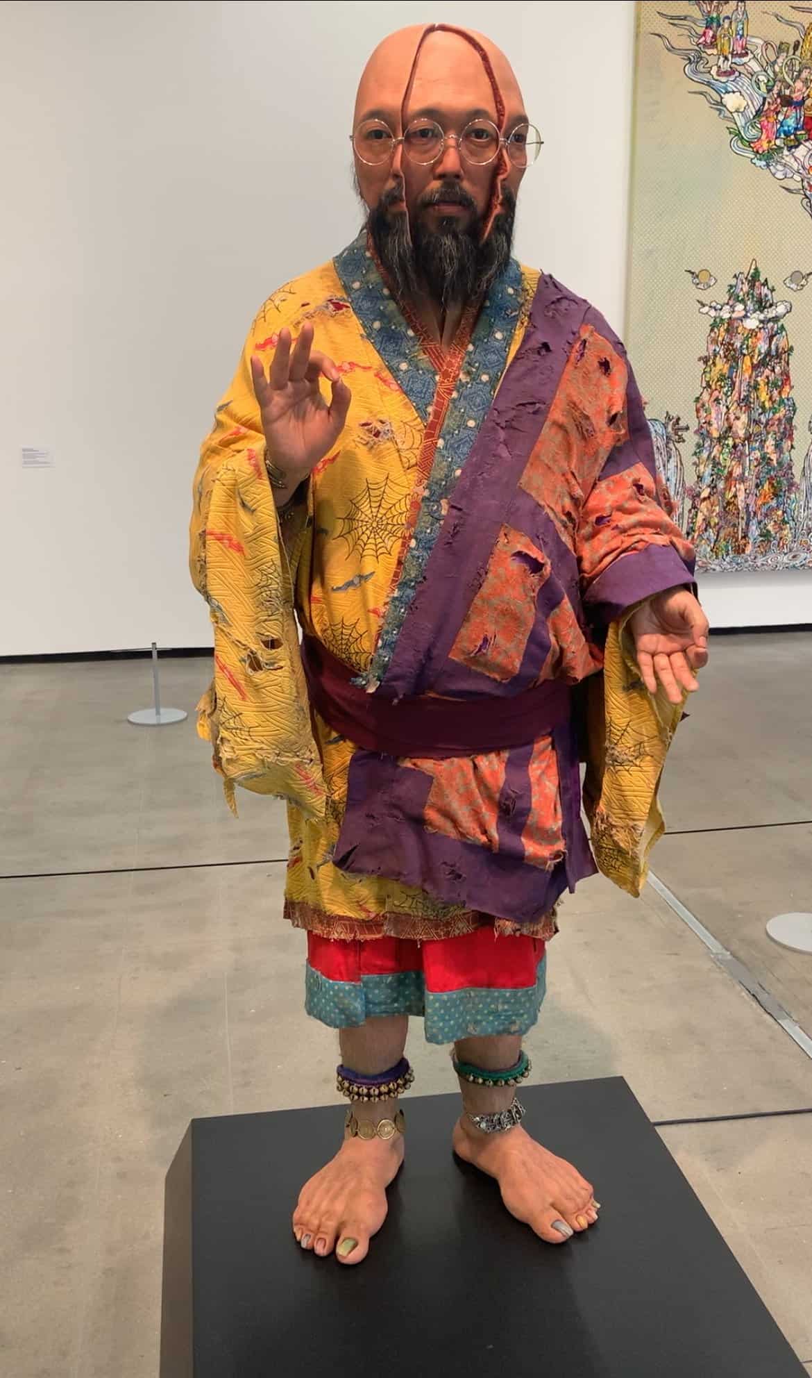 A figure in the Tomie Ohtake Institute in São Paulo, Brazil., It depicts a man with his face split in half, and his second face, which looks the same as his outside face, is revealed.