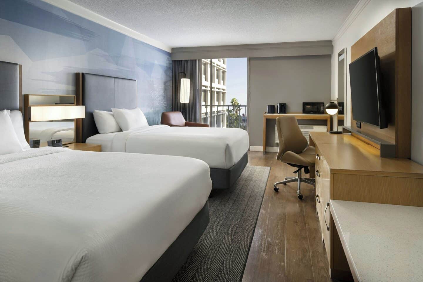 Two beds, with television and open window at Courtyard by Marriott in Long Beach, California.