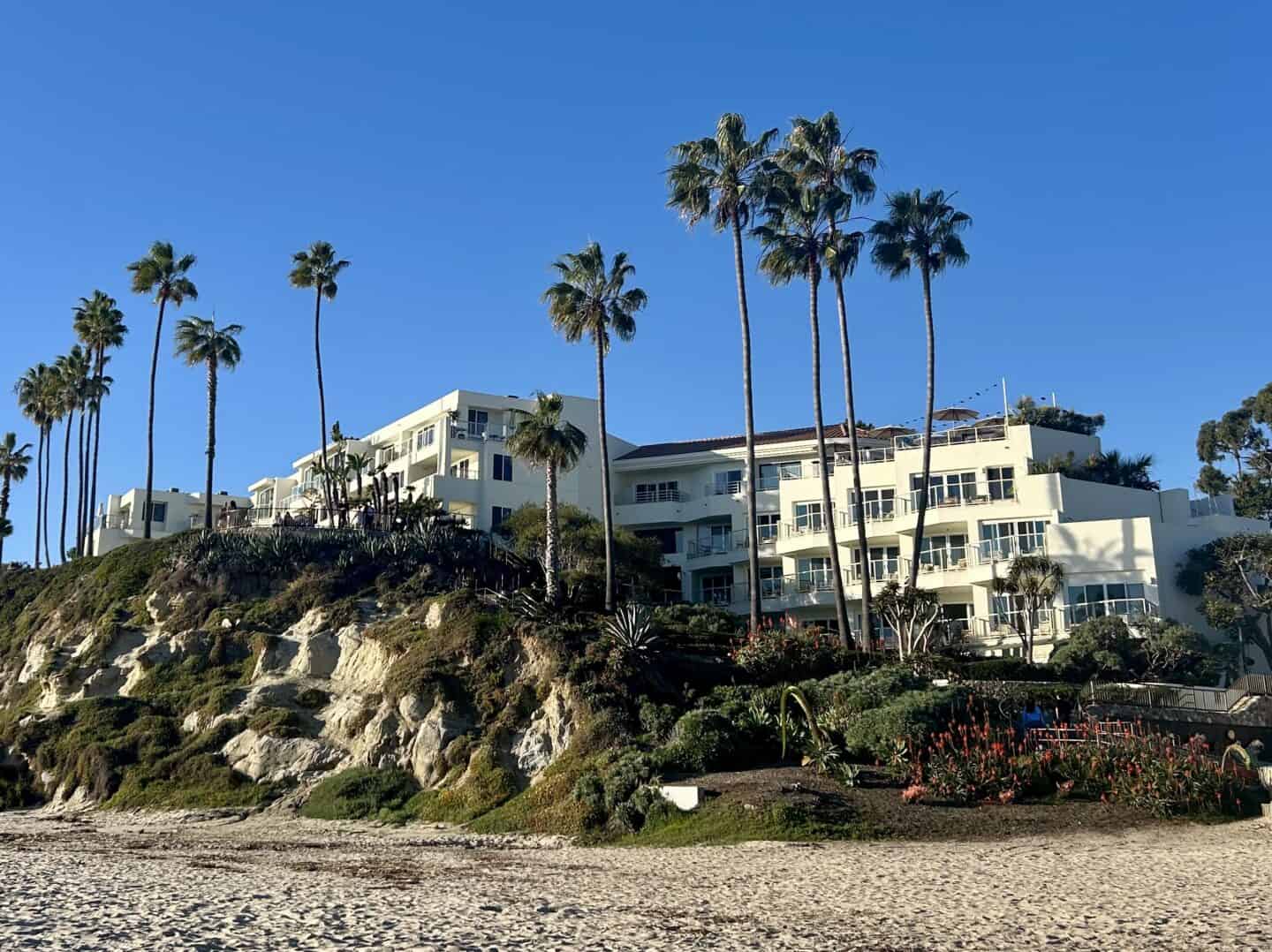 The exterior of the Mediteranean-style Casa Loma Beach Hotel in Laguna Beach, perched on a small hill over the beach.