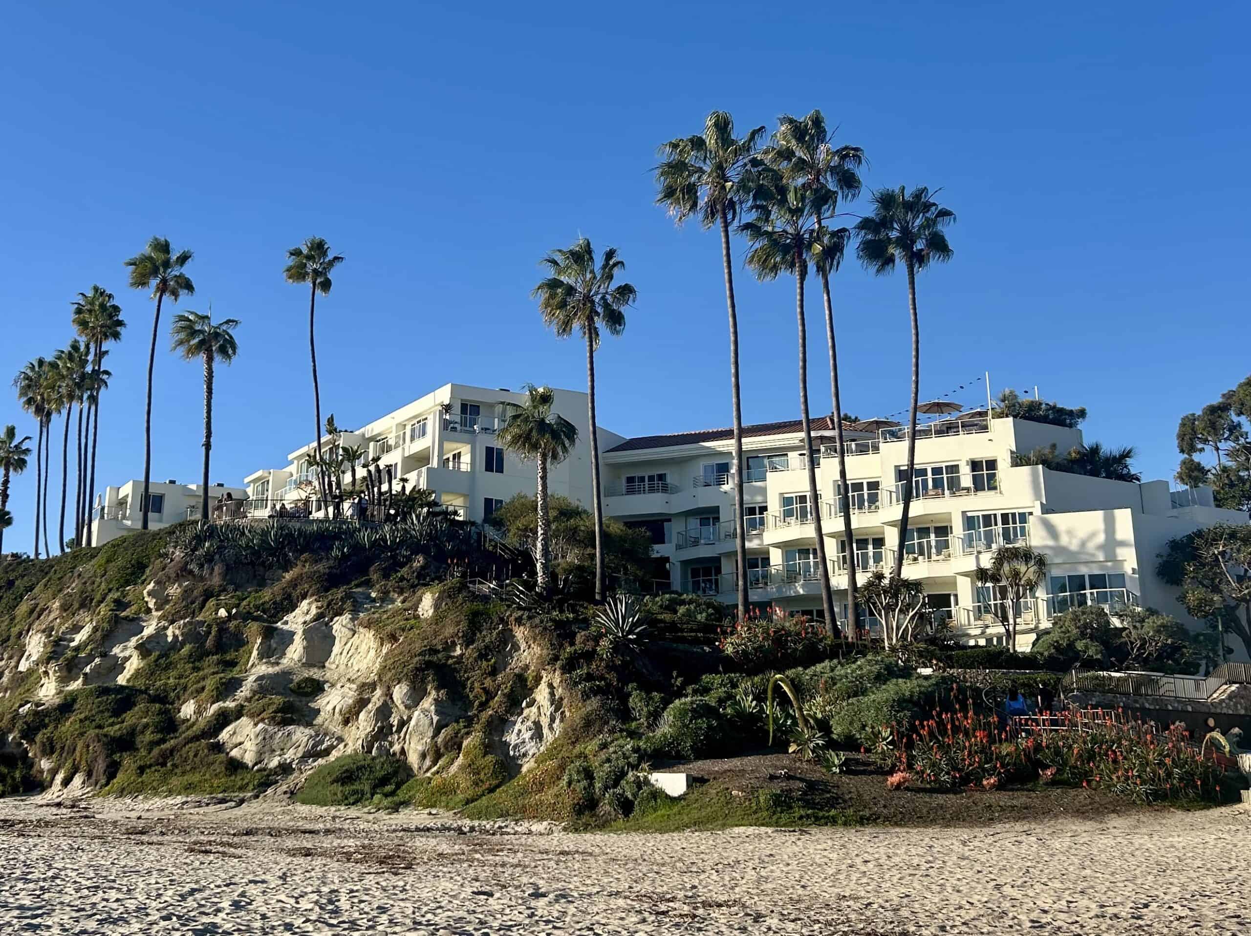 The exterior of the Mediteranean-style Casa Loma Beach Hotel in Laguna Beach, perched on a small hill over the beach.