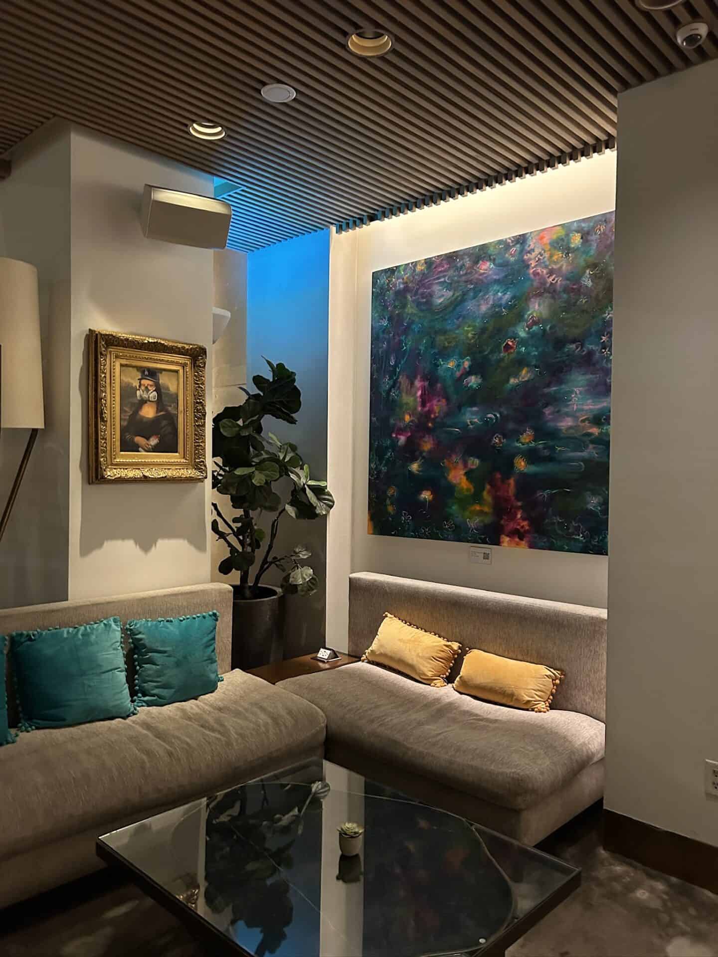 Contemporary living room featuring colorful abstract wall art and cozy seating.