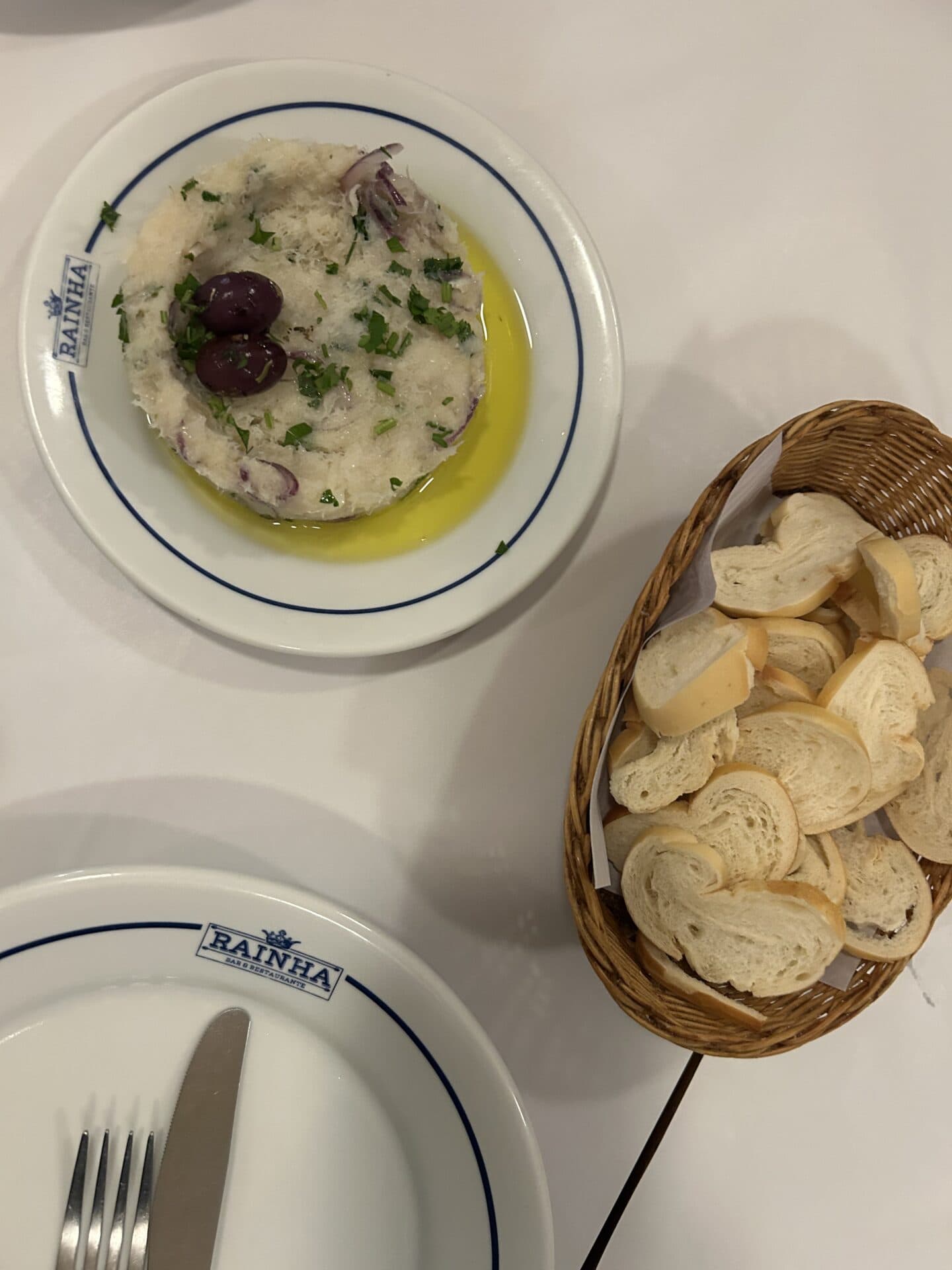 Bacalhau (cod) in olive oil, and a basket of bread from Boteco Rainha in Leblon, Rio de Janeiro.